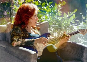 Bonnie Raitt looking out the window.