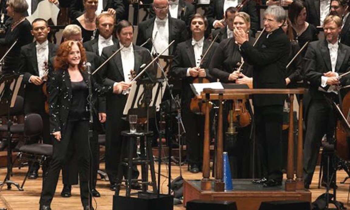 Bonnie Raitt taking a bow with Michael Tilson Thomas and musicians of the San Francisco Symphony at the orchestra's season-opening gala at Davies Symphony Hall in San Francisco on Wednesday, Sept. 3, 2014.