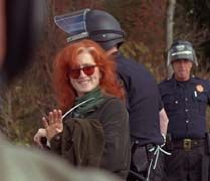 Bonnie Raitt is led away in plastic handcuffs at a demonstration against Pacific Lumber Co.'s proposal to log the Headwaters forest in Humboldt County - 1996