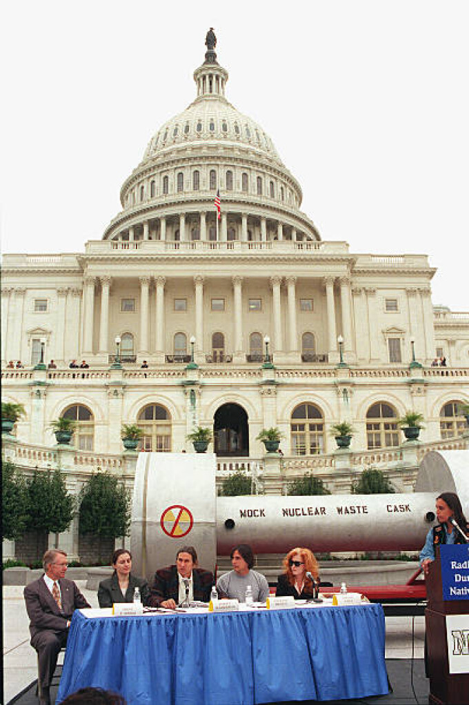 Harvey Wasserman of Greenpeace, middle, and Sen. Harry Reid, D-Nev., Dianne D'Arrigo, of the Nuclear Information Resource Service, performing artists Jackson Browne and Bonnie Raitt, and Winona LaDuke, of the Seventh Generation Fund, at a press conference on the West Terrace of the Capitol in opposition to H.R. 1270, the Nuclear Waste Policy Act of 1997, which would allow for the transfer of radioactive waste to Yucca Mountain, Nevada. Behind them is a mock nuclear waste cask. Sept.24, 1997