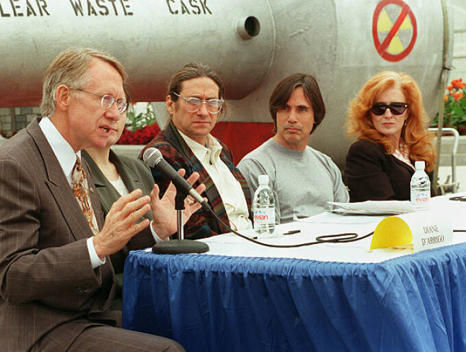 Sen. Harry Reid, D-Nev., at a press conference on the West Terrace of the Capitol in opposition to H.R. 1270, the Nuclear Waste Policy Act of 1997, which would allow for the transfer of radioactive waste to Yucca Mountain, Nevada. From left are Diane D'Arrigo (partially obscured), of the Nuclear Information Resource Service, Harvey Wasserman, of Greenpeace, and performing artists Jackson Browne and Bonnie Raitt.Behind them is a mock nuclear waste cask. Sept.24, 1997