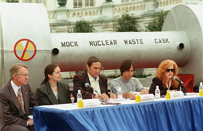 Performing artist Bonnie Raitt, right, at a press conference on the West Terrace of the Capitol in opposition to H.R. 1270, the Nuclear Waste Policy Act of 1997, which would allow for the transfer of radioactive waste to Yucca Mountain, Nevada. From left are Sen. Harry Reid, D-Nev., Diane D'Arrigo, of the Nuclear Information Resource Service, Harvey Wasserman, of Greenpeace, and performing artist Jackson Browne. Behind them is a mock nuclear waste cask.  Sept.24, 1997